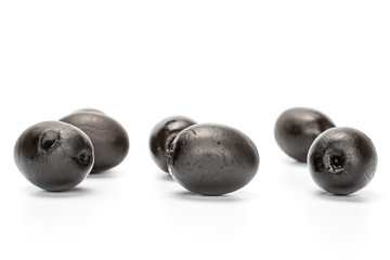Group of six whole canned black olive isolated on white background