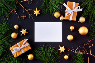 Mockup white greeting card with gold christmas balls, pine branches and gift box on a dark background