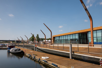 Modern and wooden marina club building in Szczecin, Poland. Boats, motorboat moored at the bank