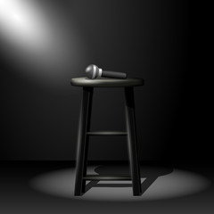 Stand up comedy stage - microphone on stool in ray of spotlight