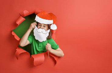 girl in Santa hat on color background