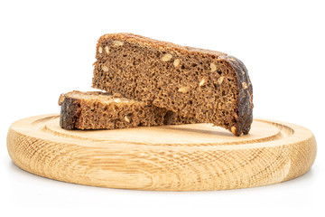 Group of two pieces of fresh baked dark bread on bamboo plate isolated on white background