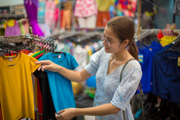 Asian women choose to buy clothes in the wholesale market of clothing in department stores.