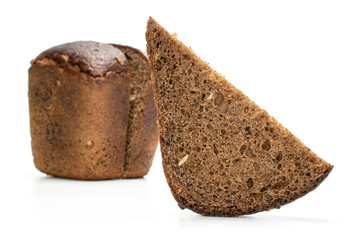 Group of two halves one slice of fresh baked dark bread front focus isolated on white background