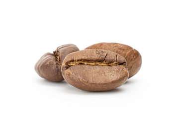 Group of three whole coffee beans isolated on white background