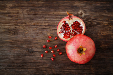 Ripe and fresh pomegranate peeled and ready for eat on wooden beackground