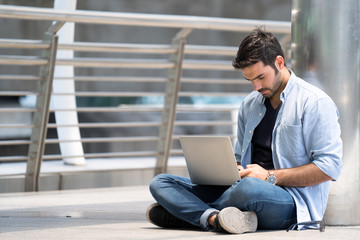 Young architects, thinkers, analyze and plan work during the break with smartphones and laptops.