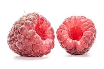 Group of three whole fresh crimson raspberry isolated on white background