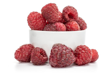 Lot of whole fresh crimson raspberry in white sauce bowl isolated on white background