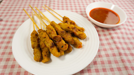 Pork satay eating with peanut sauce . Thai style food