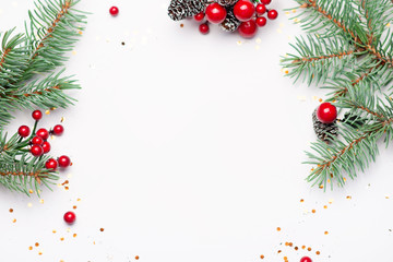 Christmas composition flatlay. Spruce branches, red berries on white background with space for text