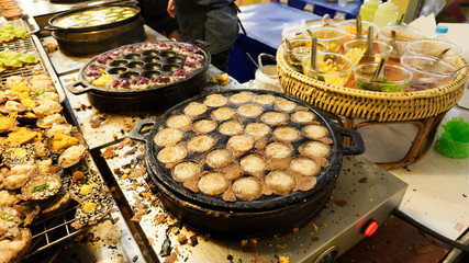 Khanom Khrok (coconut rice pancake), Traditional Thai Dessert at street food market.      