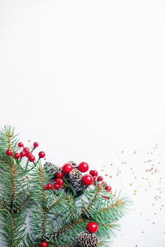 Christmas composition flatlay. Spruce branches, red berries on white background with space for text