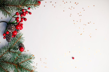 Christmas composition flatlay. Spruce branches, red berries on white background with space for text
