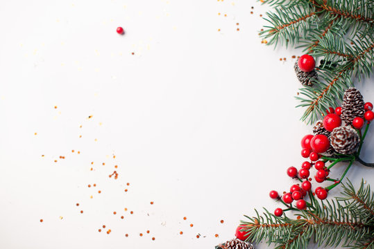 Christmas composition flatlay. Spruce branches, red berries on white background with space for text