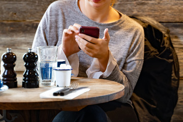 women using smartphone chatting while having coffee in  cafe. for checking pictures and SMS...