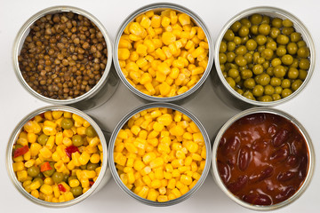 Canned food on white background. Green pea, beans, corn, lentils.