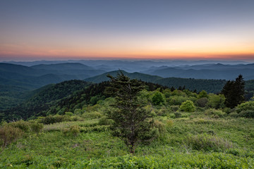 View of sunset from Cowee Mountain Overlook on Blue Ridge Parkway in summer.	