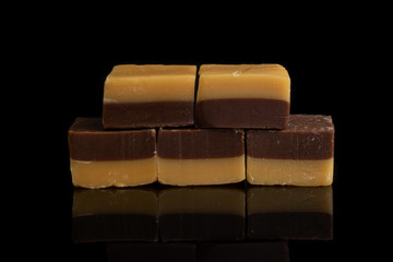 Group of five whole sweet brown caramel chocolate candy isolated on black glass
