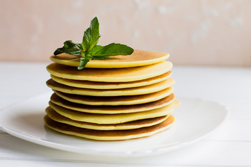 pancakes with raspberries on a white plate