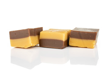 Group of three whole sweet brown caramel chocolate candy in row isolated on white background