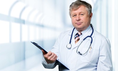 Young man doctor holding stethoscope