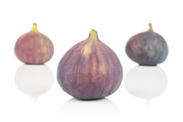 Group of three whole fresh purple fig isolated on white background
