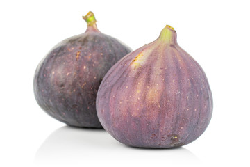 Group of two whole fresh purple fig isolated on white background