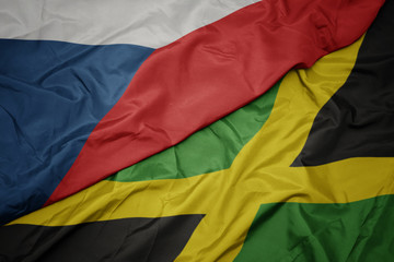 waving colorful flag of jamaica and national flag of czech republic.