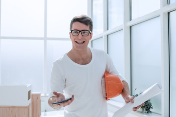 close up. experienced architect with smartphone standing in Studio