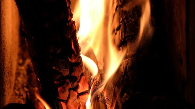 Detail of burning wood fire in wood-burning stove, close up, 4k