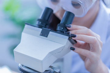 Asian female doctor working on laptop with a microscope for an exam at hospital giving patient convenience online service advice, smiling write a prescription , healthcare, preventing disease concept