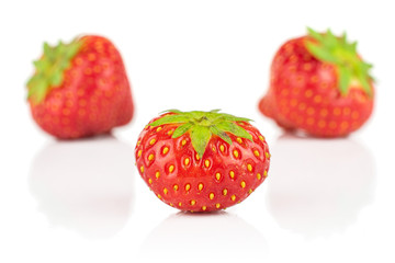 Group of three whole fresh red strawberry isolated on white background