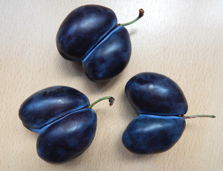 Three plums of unusual shape