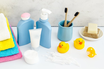 Baby bathroom cosmetics near pacifier and rubber duck on white background