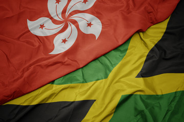 waving colorful flag of jamaica and national flag of hong kong.