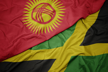 waving colorful flag of jamaica and national flag of kyrgyzstan.