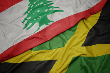 waving colorful flag of jamaica and national flag of lebanon.