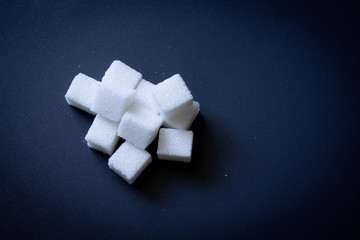 Cubes of sugar on a black backgound