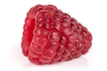 One whole fresh red raspberry in close up isolated on white background