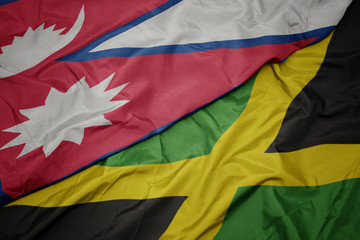 waving colorful flag of jamaica and national flag of nepal.