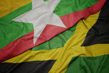 Obraz premium waving colorful flag of jamaica and national flag of myanmar.