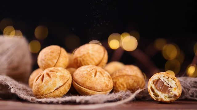 Christmas baking. Homemade Russian cookies "Nut". Cookies in the form of a nut from two shells with cream inside. Homemade cookies shaped nuts with cream boiled condensed milk on wooden table.
