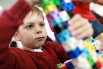 Kid playing plastic constructor