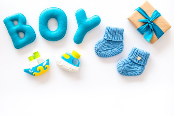 Boy's birthday concept. Set in blue colors with gift box on white backgound top view frame copy space