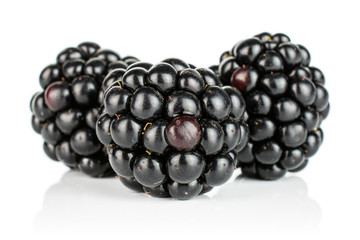 Group of three whole fresh black blackberry isolated on white background