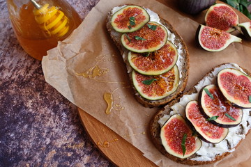 Sandwich with figs, cheese, nuts and honey. Selective focus, close-up. Top view.