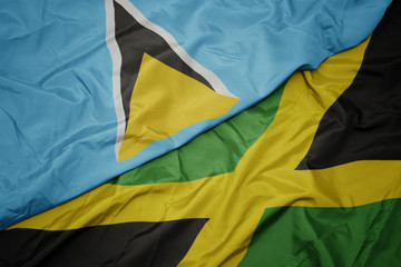 waving colorful flag of jamaica and national flag of saint lucia