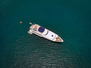 Top view of the luxurious yacht in the vast blue sea; lifestyle concept.