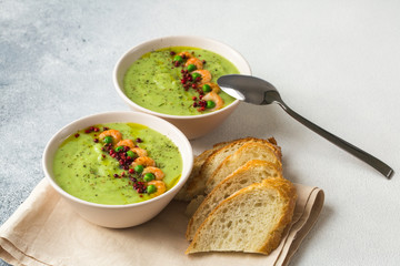 Green peas soup with shrimps, pink pepper